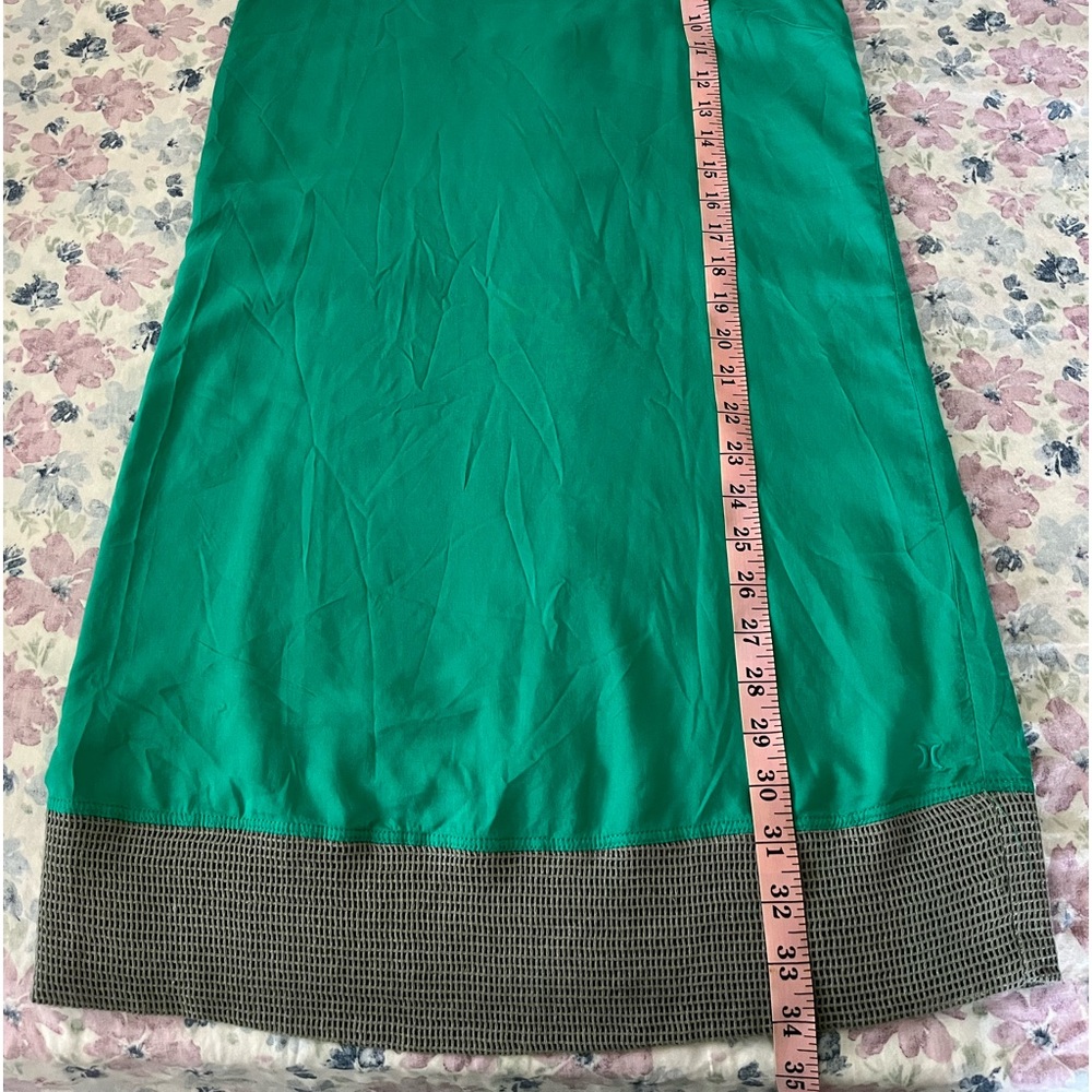 Hurley green dress with criss cross back and mesh-like hem.